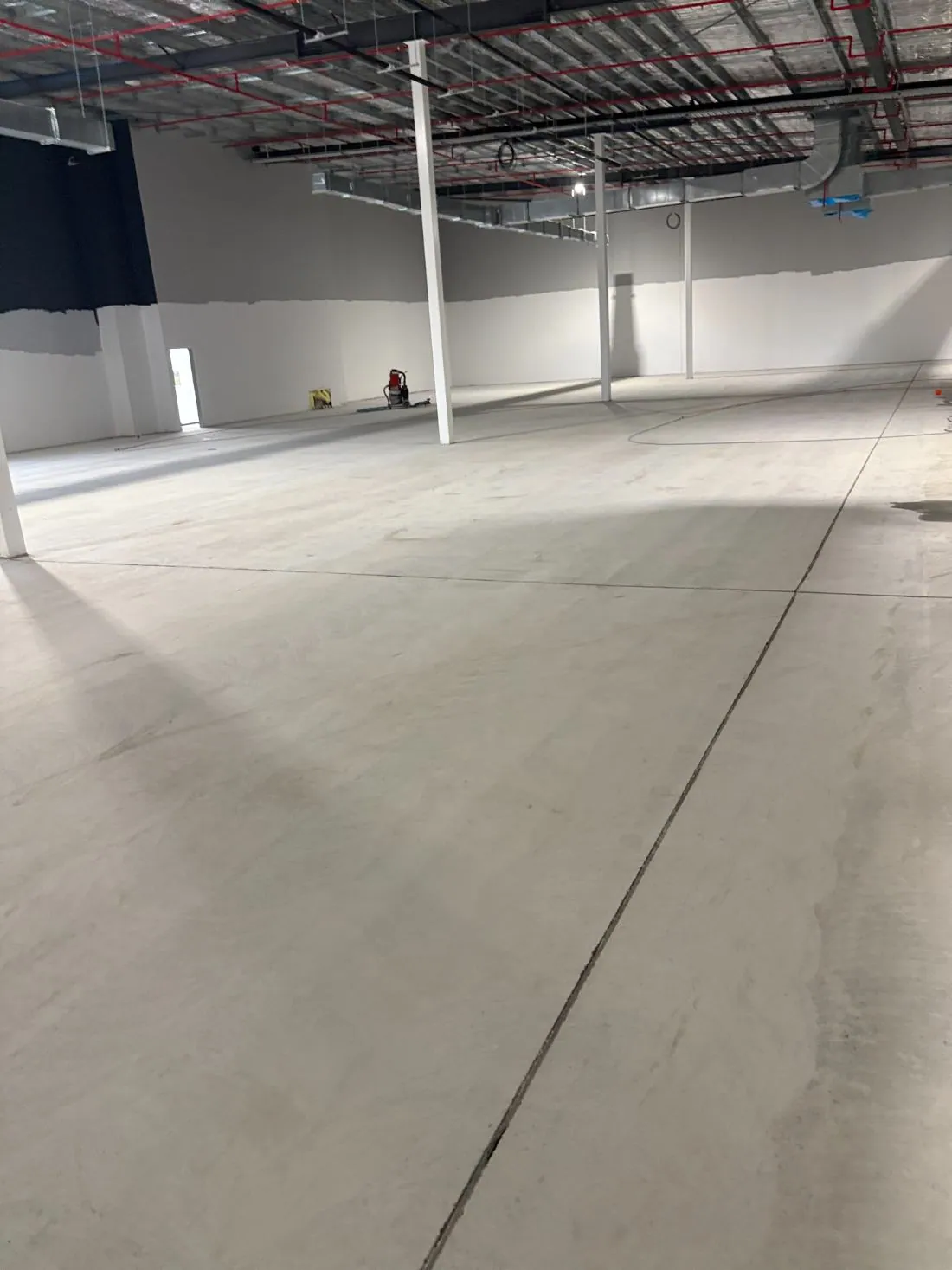 Warehouse slab after concrete grinding and preparation