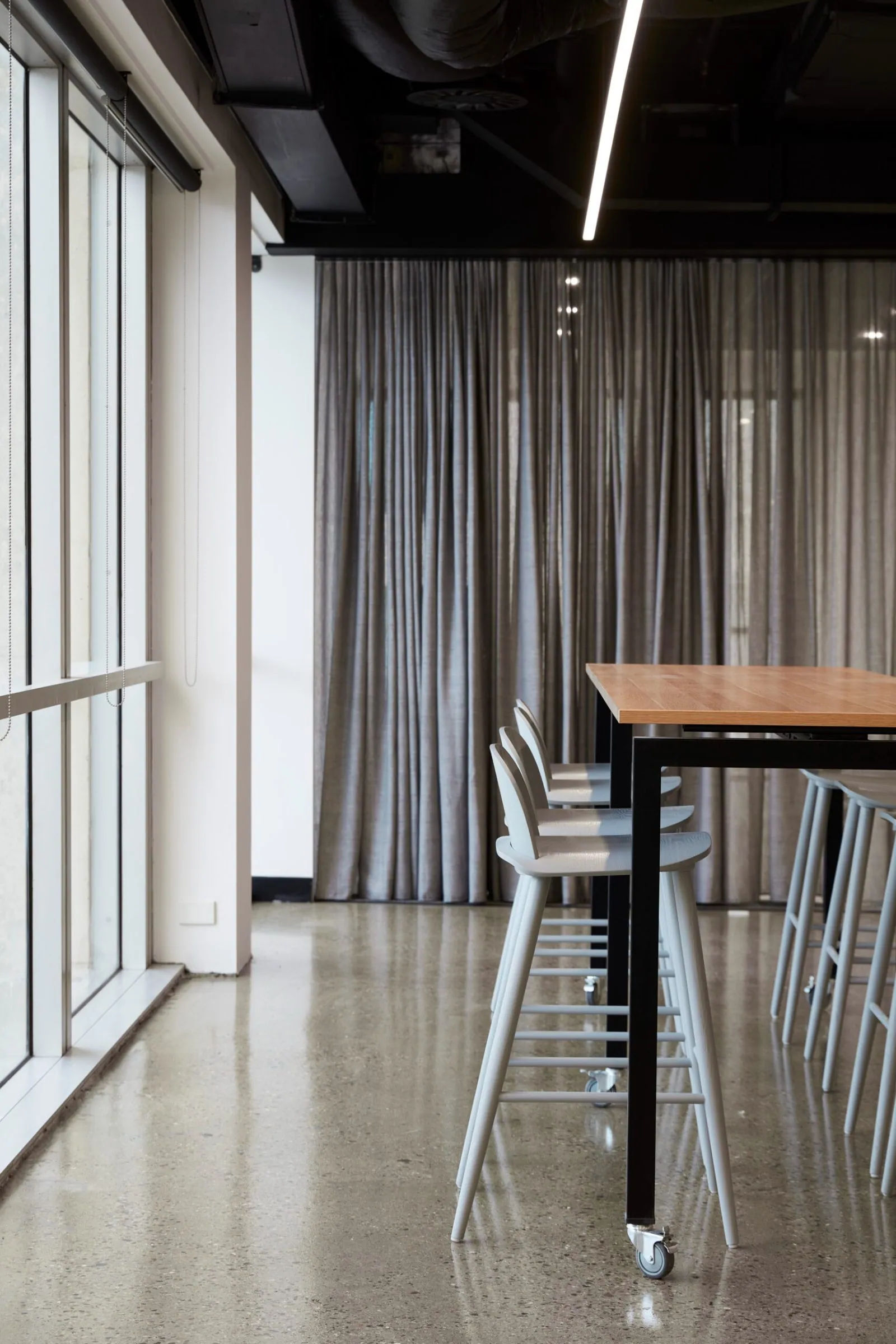 Grind and seal polished concrete floor in a bar bench beside the office windows at the Archway commercial office fit-out, Brisbane