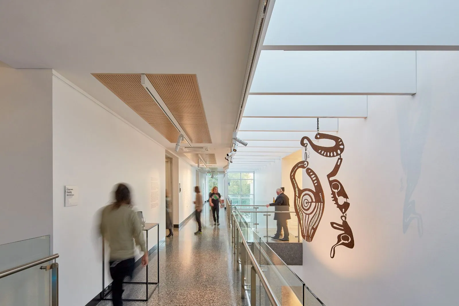 Mezzanine corridor with a suspended sculpture above a mechanically polished concrete floor at Murray Art Museum Albury