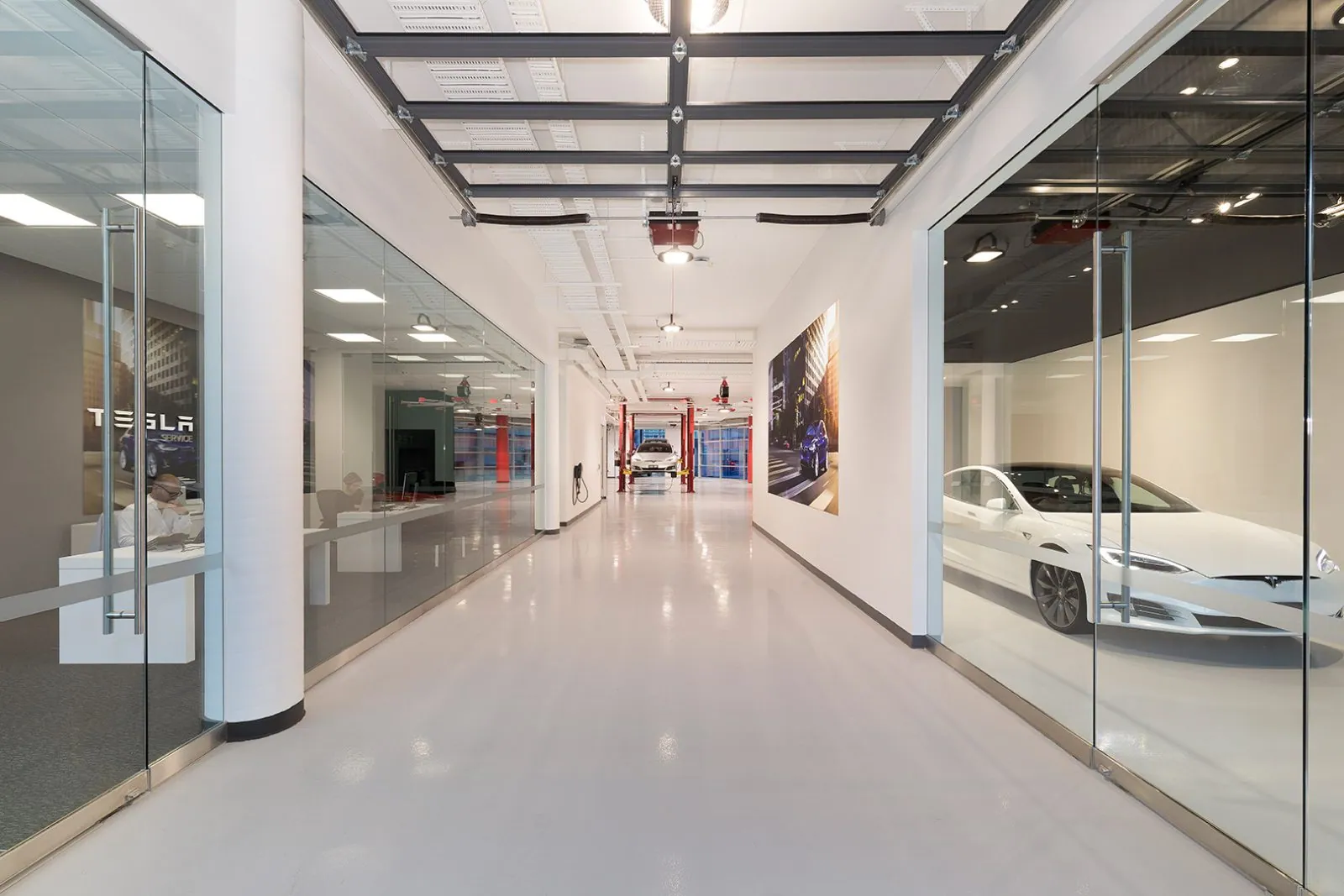Tesla service centre workshop with a durable solid colour epoxy floor, OzGrind commercial epoxy flooring Brisbane