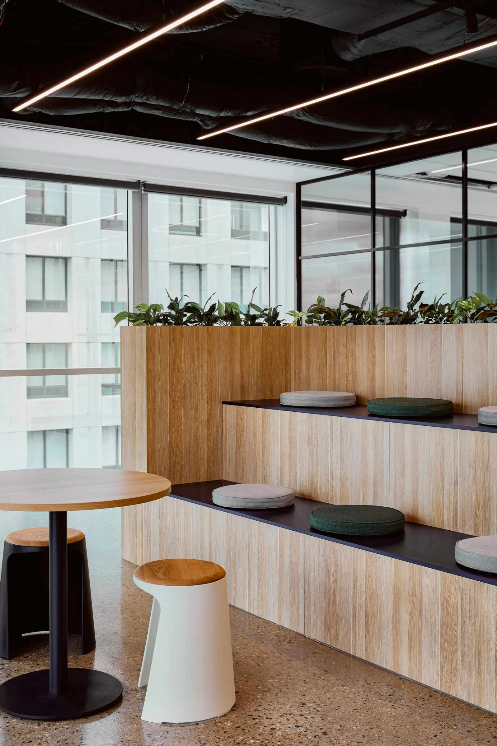 Grind and seal polished concrete floor in a tiered breakout with city views at the Archway commercial office fit-out, Brisbane