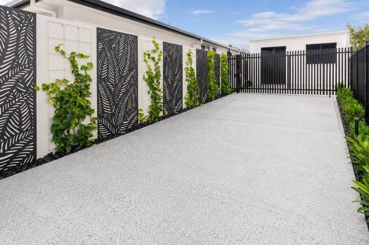 Honed concrete driveway courtyard with exposed aggregate and climbing plants Gold Coast