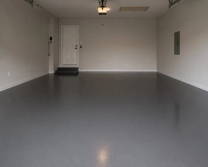 Solid colour epoxy garage floor Dark grey solid colour epoxy garage floor in a residential garage