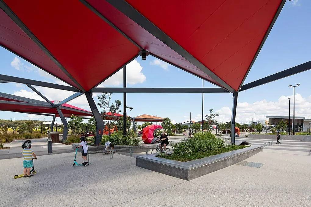 Honed concrete public path and pergola through the parkland at Stockland Aura, Baringa