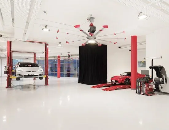 Epoxy floor Tesla service centre White epoxy floor in a Tesla service centre with vehicle hoists
