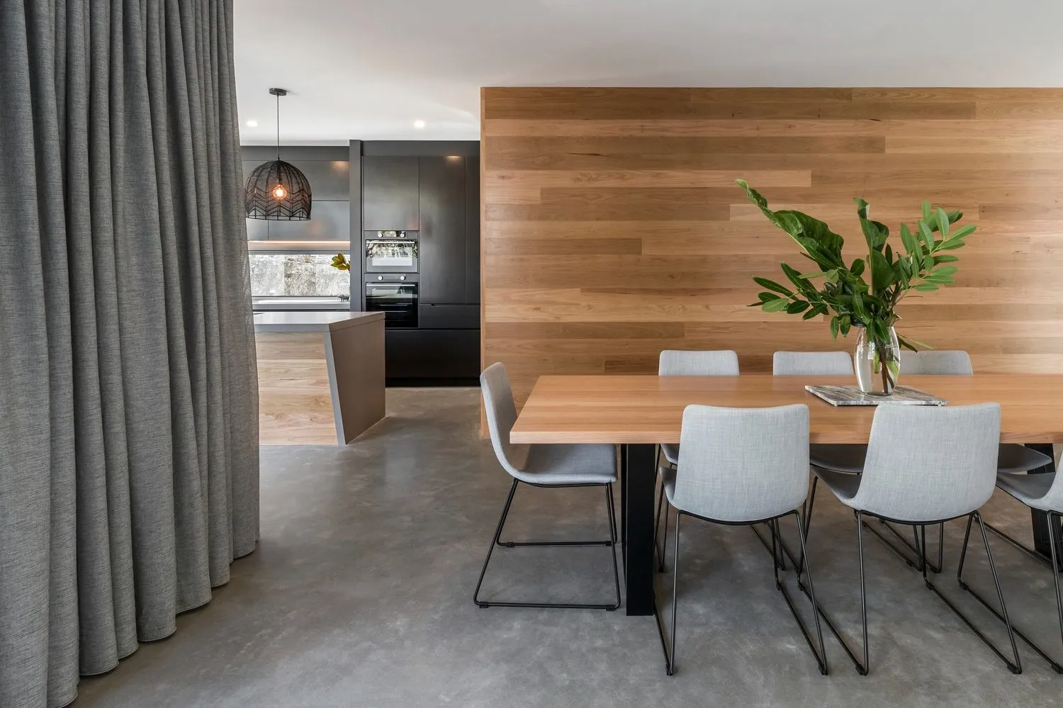 Honed and polished concrete floor in the open plan dining and living area of the Duffy house, as seen on Ready Set Reno