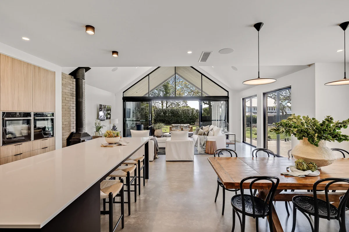 Natural polished concrete floor in a Gold Coast home with a vaulted ceiling and soft matte cement look