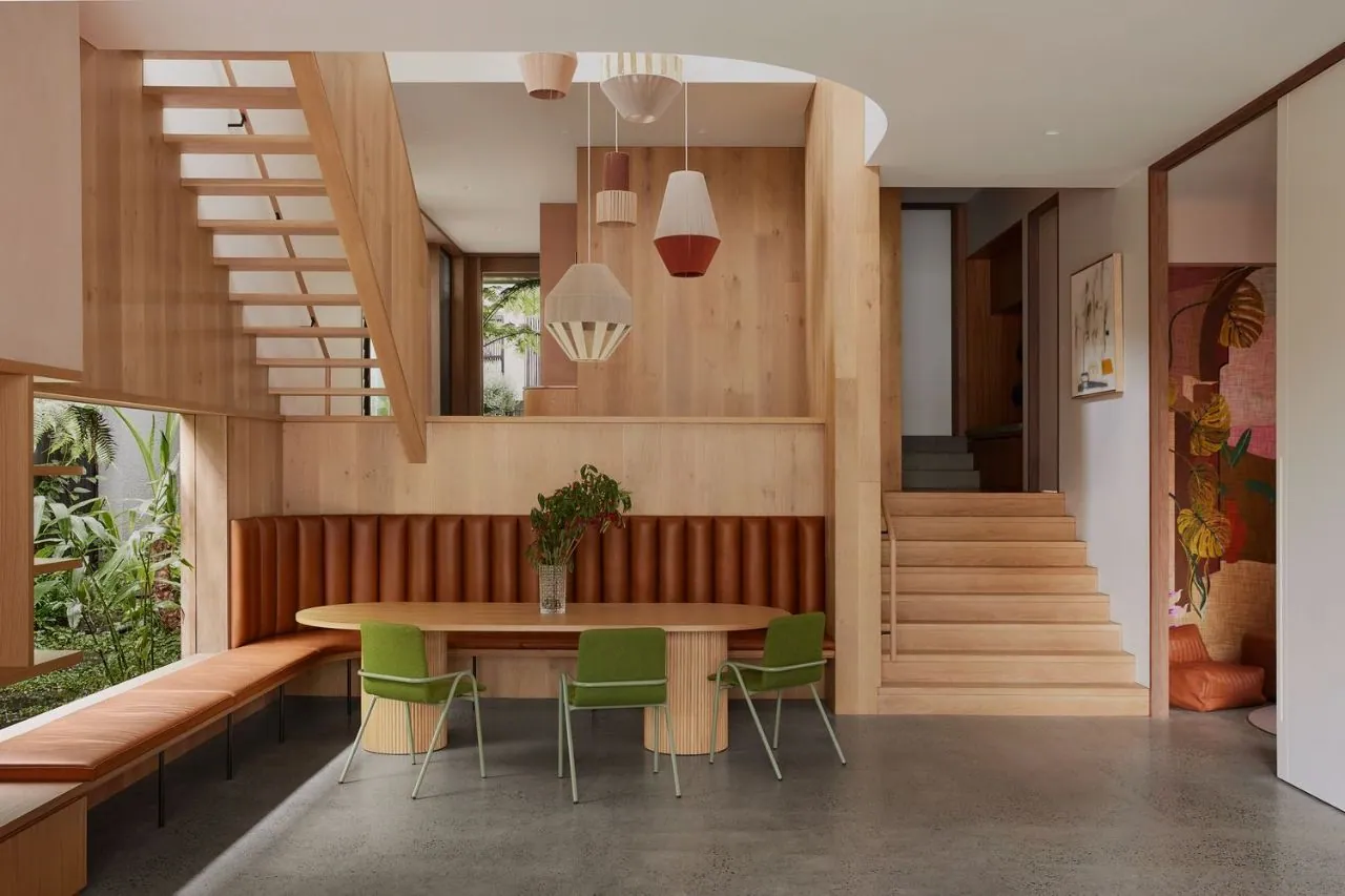 Minimal exposure polished concrete in a timber-lined dining area