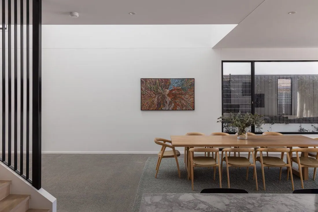 Timber dining setting on a minimum exposure semi gloss polished concrete floor at the Eclat Building home, Hendra
