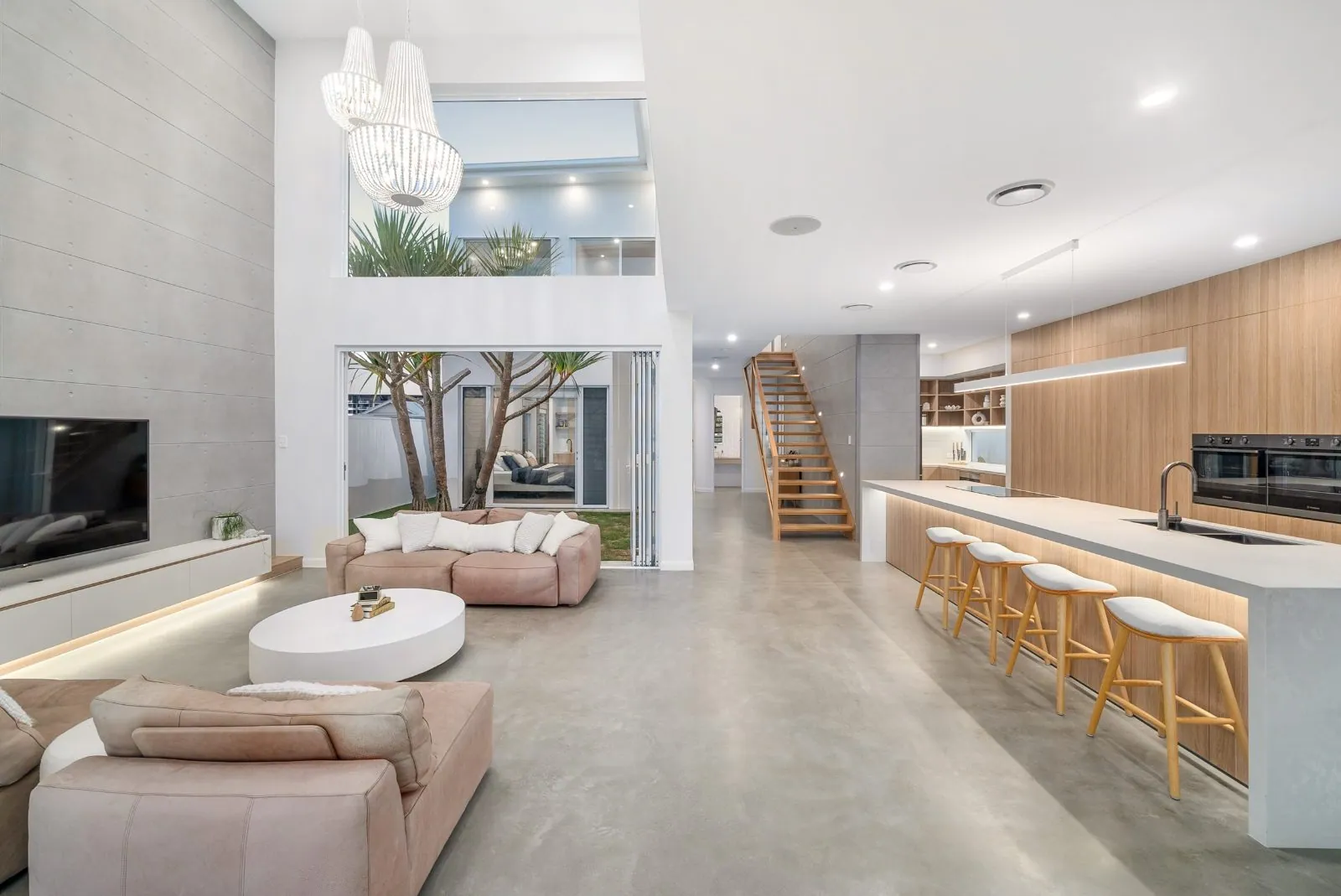 Nil to minimal exposure polished concrete floor in an open-plan Brisbane living and kitchen area with a smooth matte natural cement look