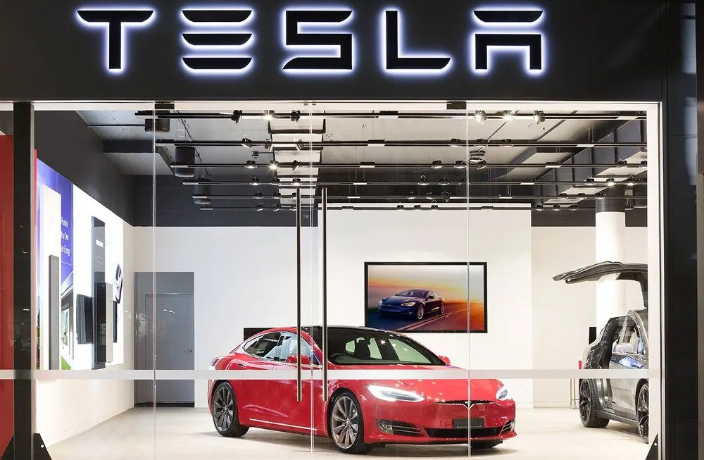 Red Tesla Model S behind the glass storefront of the Tesla showroom on an epoxy coated floor, Fortitude Valley Brisbane