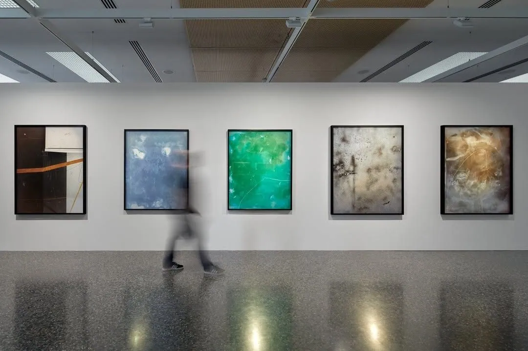 Row of framed works above a polished concrete gallery floor at Murray Art Museum Albury