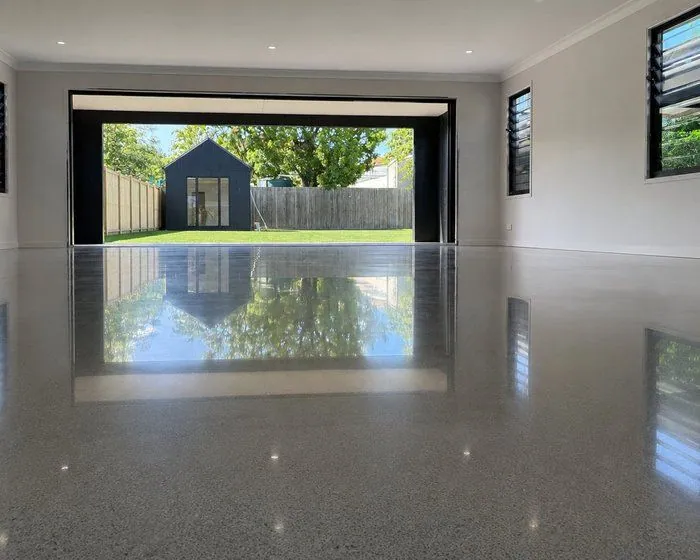 Polished concrete floor Brisbane High-gloss polished concrete floor in a Brisbane home opening to the backyard