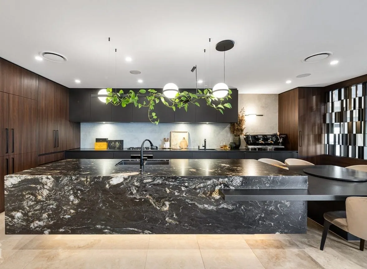 Polished black granite island benchtop in a luxury Brisbane kitchen