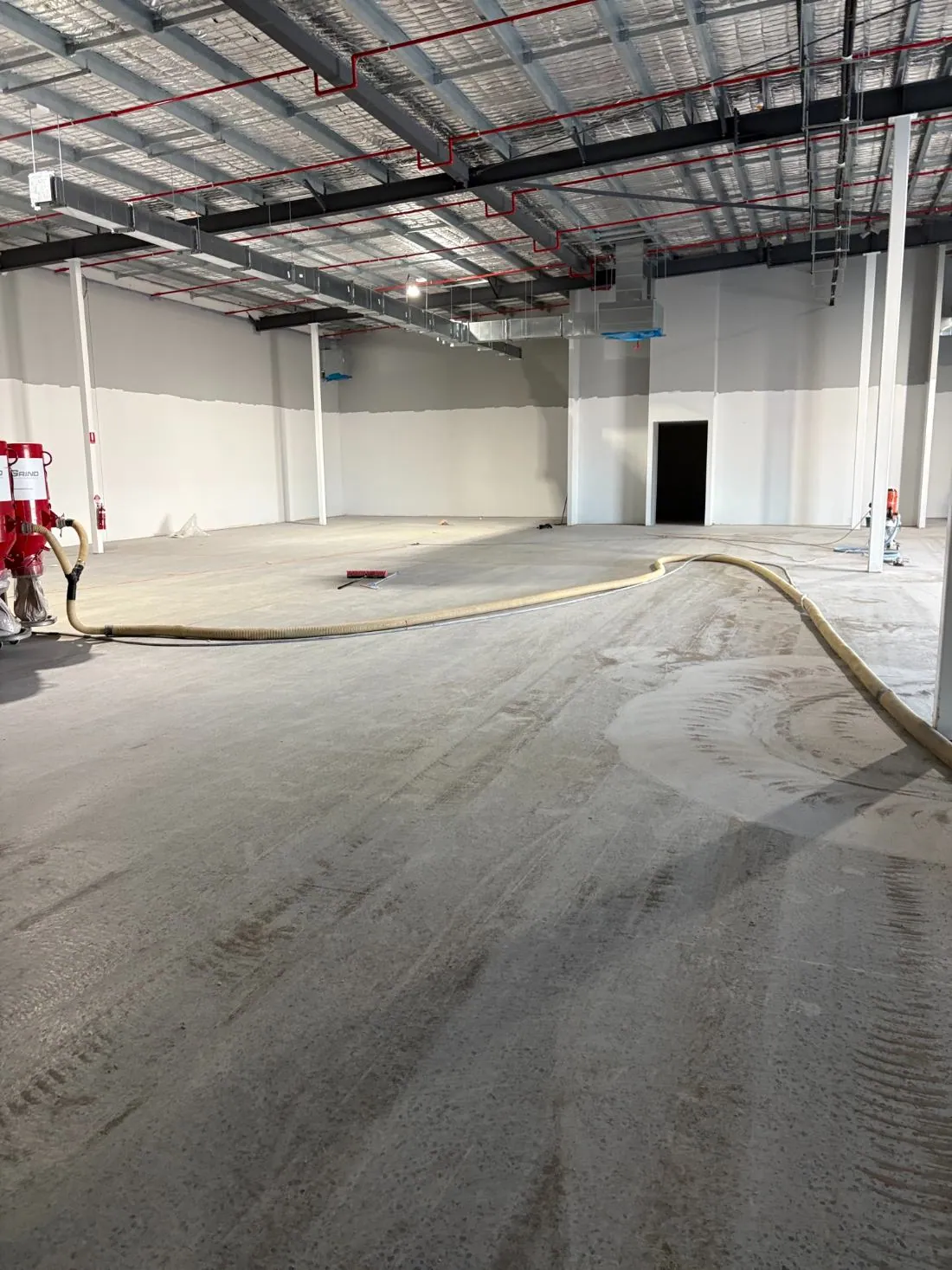 Large-area floor grinding across a commercial tenancy