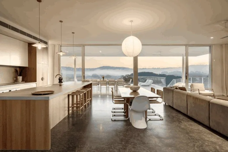 Burnished concrete open-plan kitchen and living floor with district views in Brisbane
