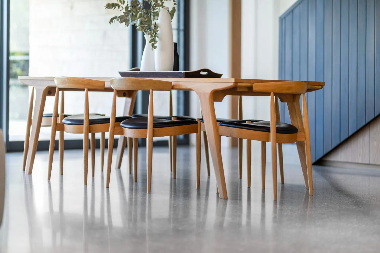 Nil exposure polished concrete floor beneath a timber dining setting