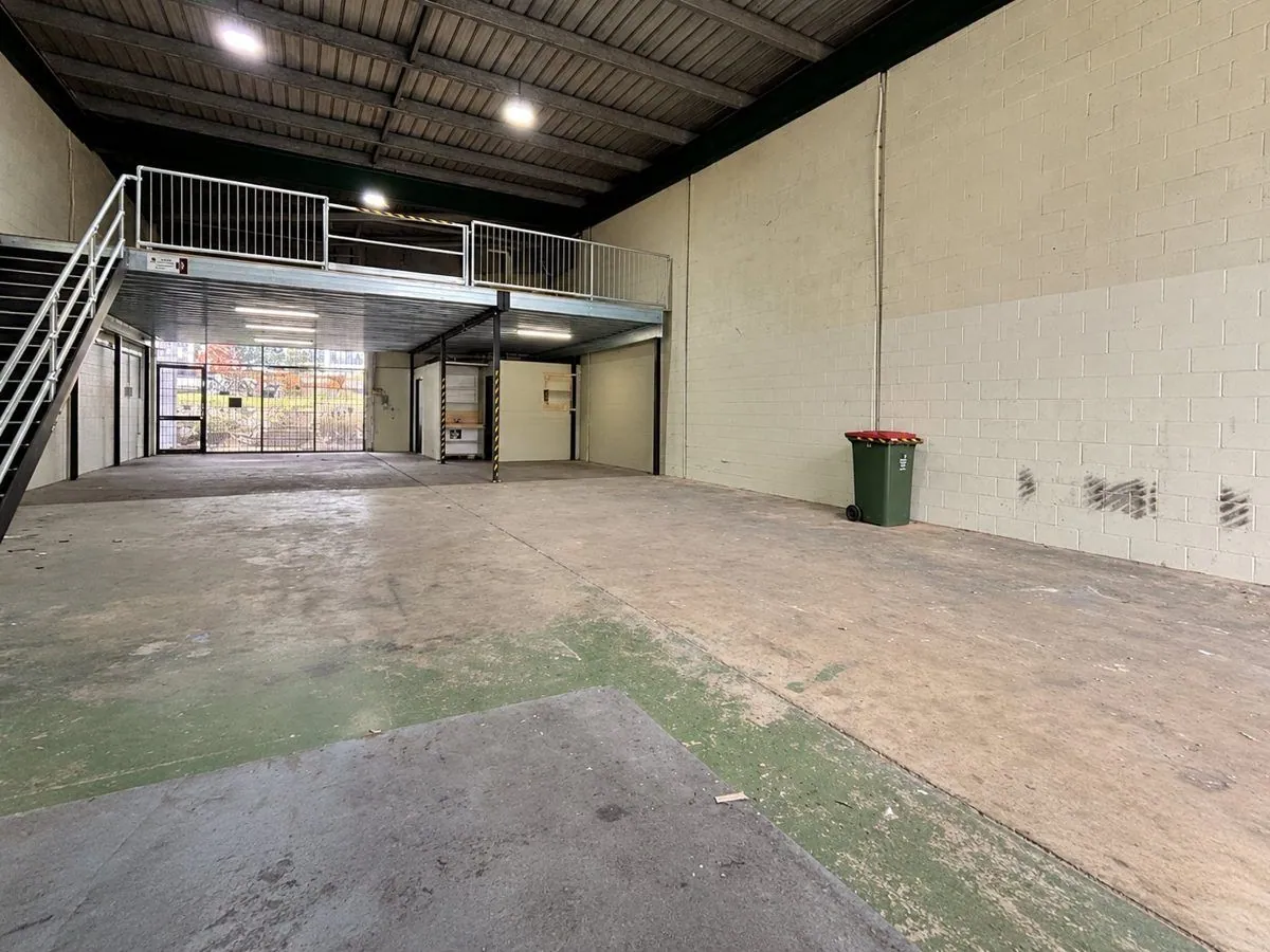 Industrial unit floor before epoxy, stained, worn concrete slab, Brisbane