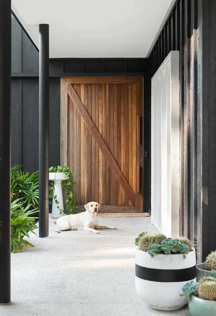 Polished concrete entry floor with a timber pivot door at a Ready Set Reno home by OzGrind