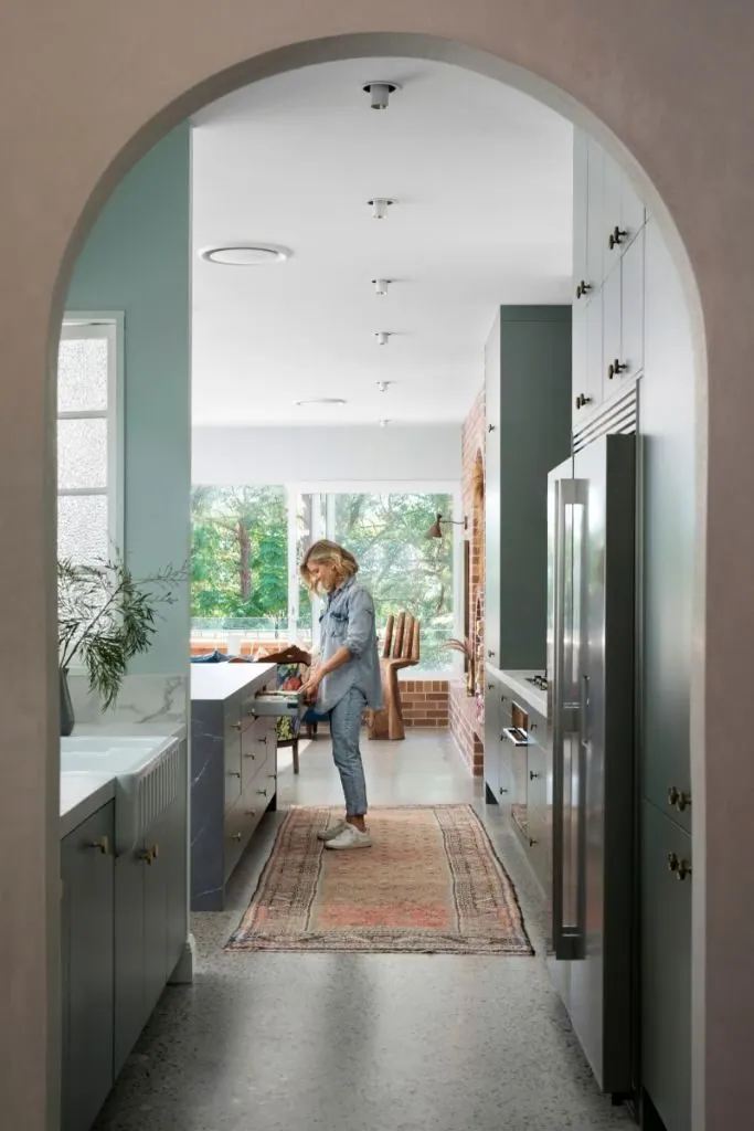 Polished concrete floor through an arched hallway and kitchen at a Ready Set Reno home by OzGrind