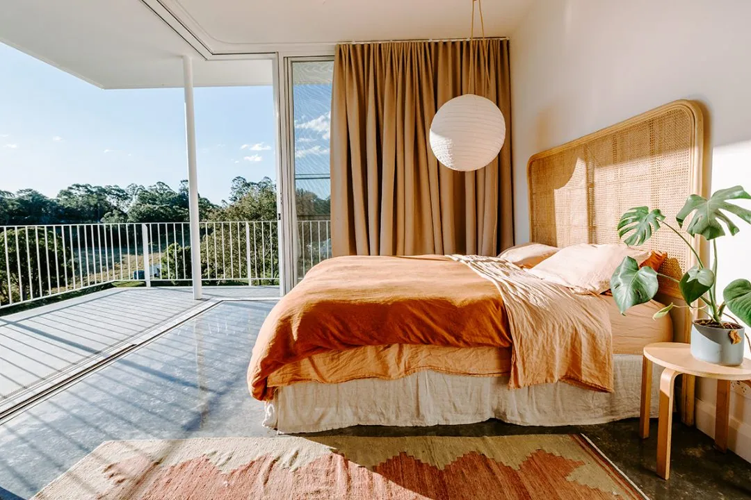 Mechanically polished concrete floor in a sunlit Brisbane bedroom with balcony views