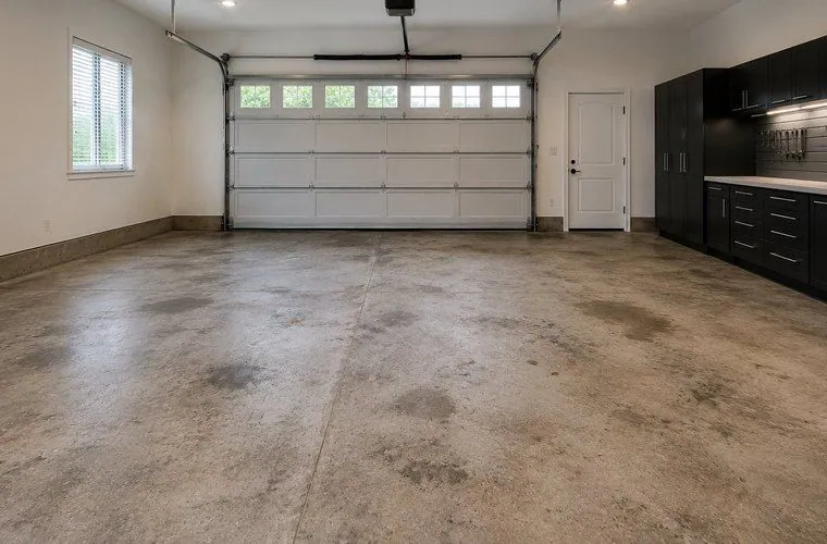 Garage floor before Bare stained concrete garage floor before coating in Brisbane