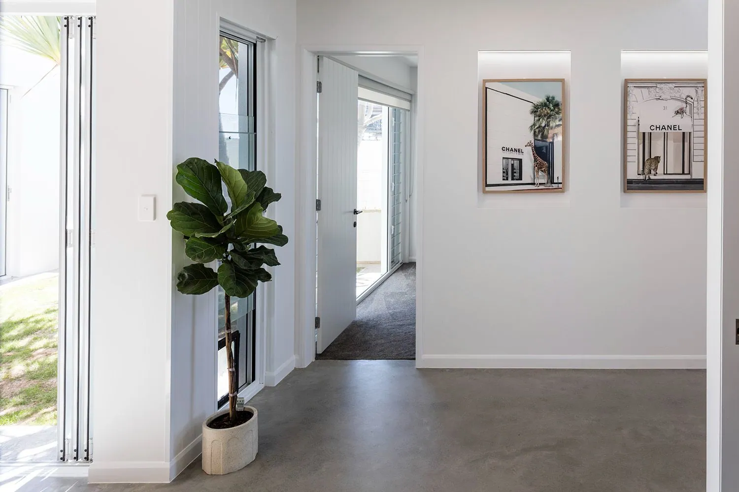 Polished concrete floor flowing to the alfresco and pool at a Monster Homes waterfront residence, Brisbane