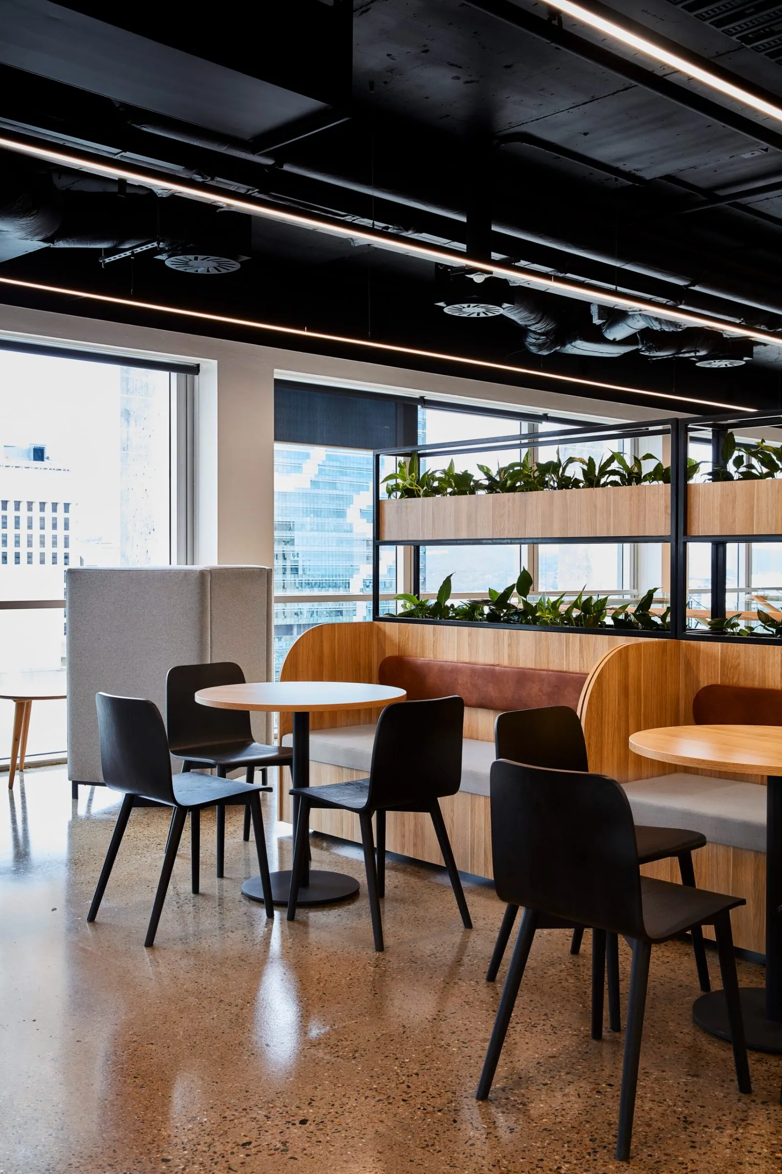 Grind and seal polished concrete floor in an office breakout beside full height curtains at the Archway commercial office fit-out, Brisbane