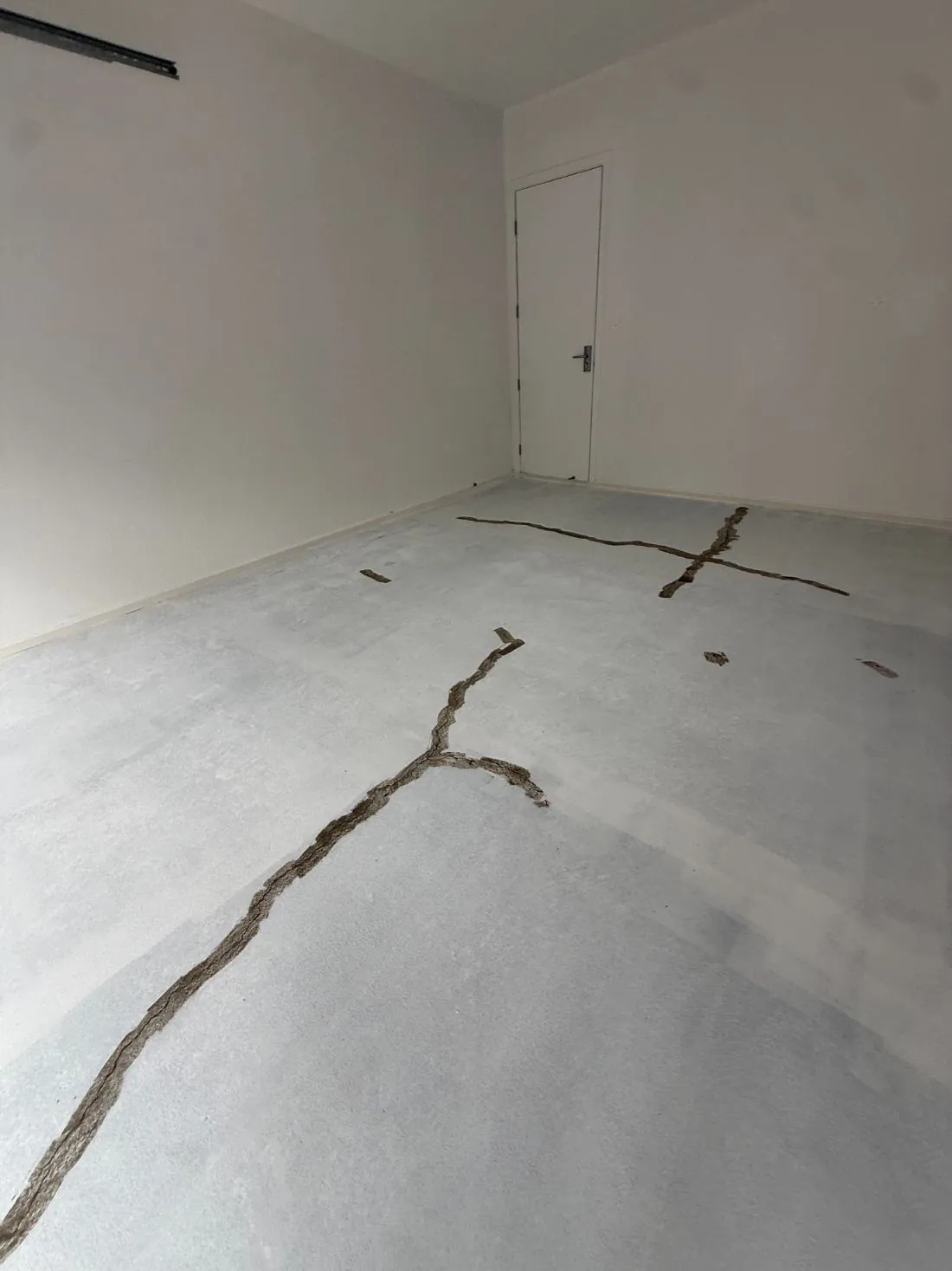 Crack repair and slab preparation in a residential renovation
