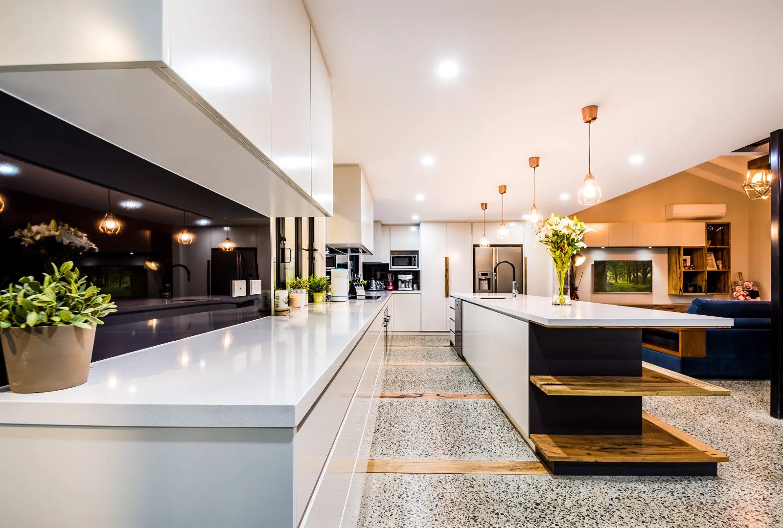 Polished concrete kitchen and floating timber staircase, Alexandra Hills renovation Brisbane