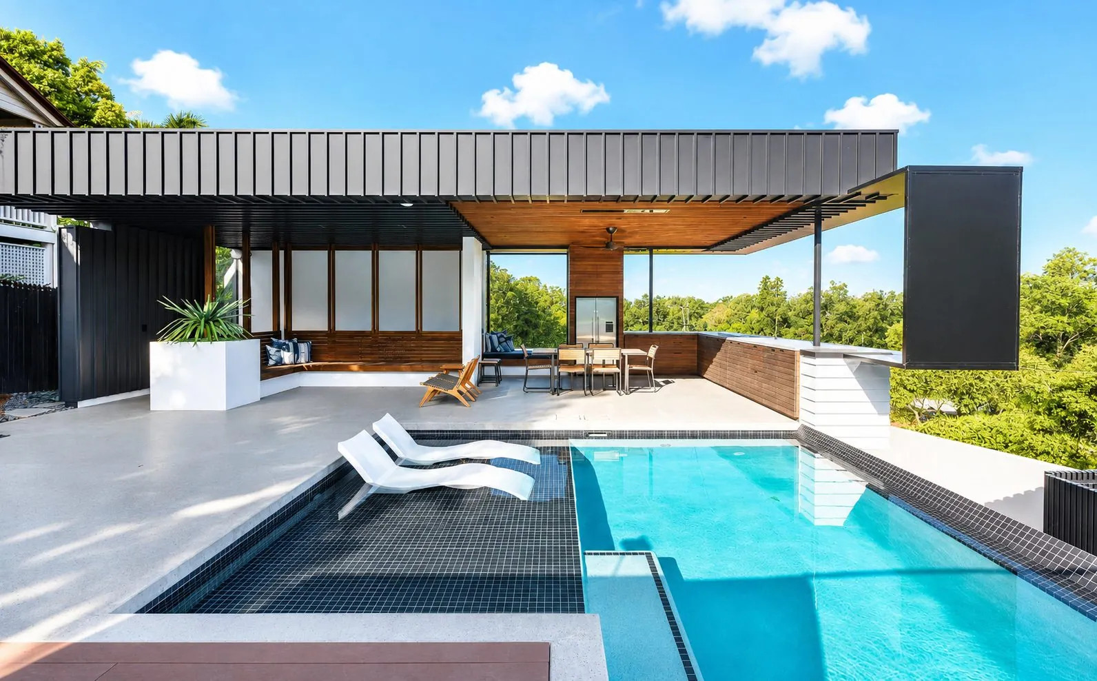 Honed concrete pool surround at an architectural home with covered alfresco on the Gold Coast