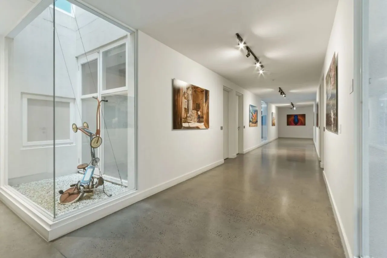 Minimal exposure polished concrete along a gallery-style hallway