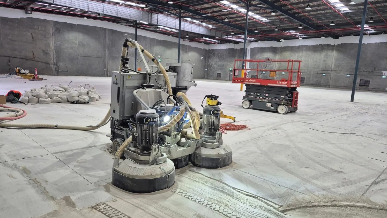 Planetary grinder preparing a warehouse floor for a make good