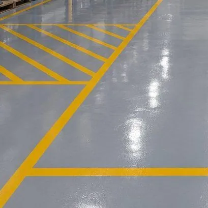 Yellow safety zoning line-marking on an epoxy floor