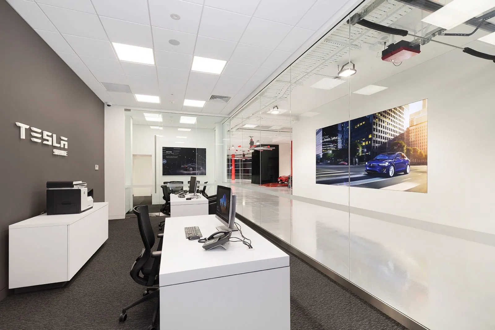 Tesla showroom building exterior at dusk in Fortitude Valley, an OzGrind commercial epoxy flooring project, Brisbane