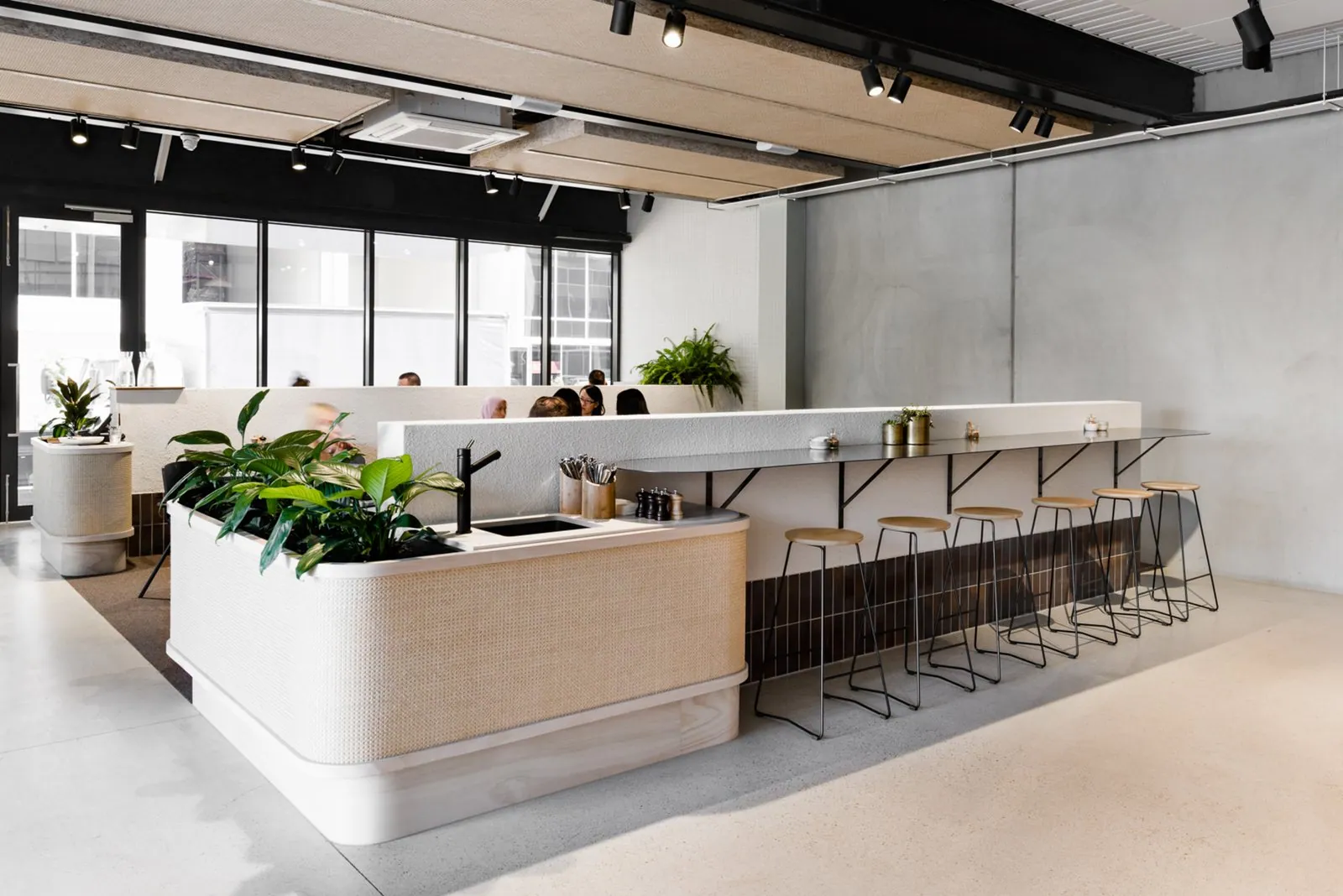 Grind and seal concrete floor in a Brisbane cafe with rattan counter
