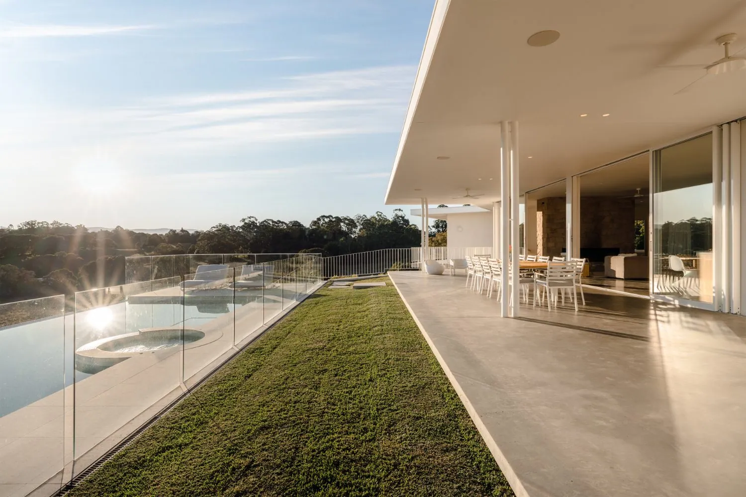 Honed concrete terrace beside an infinity pool with rural views near Brisbane