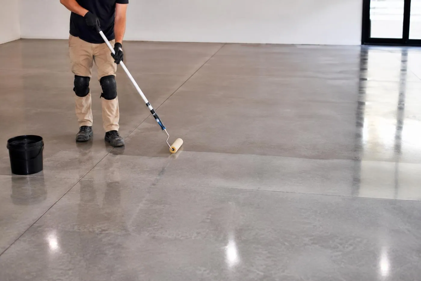 A protective sealer being applied to a concrete floor in Brisbane