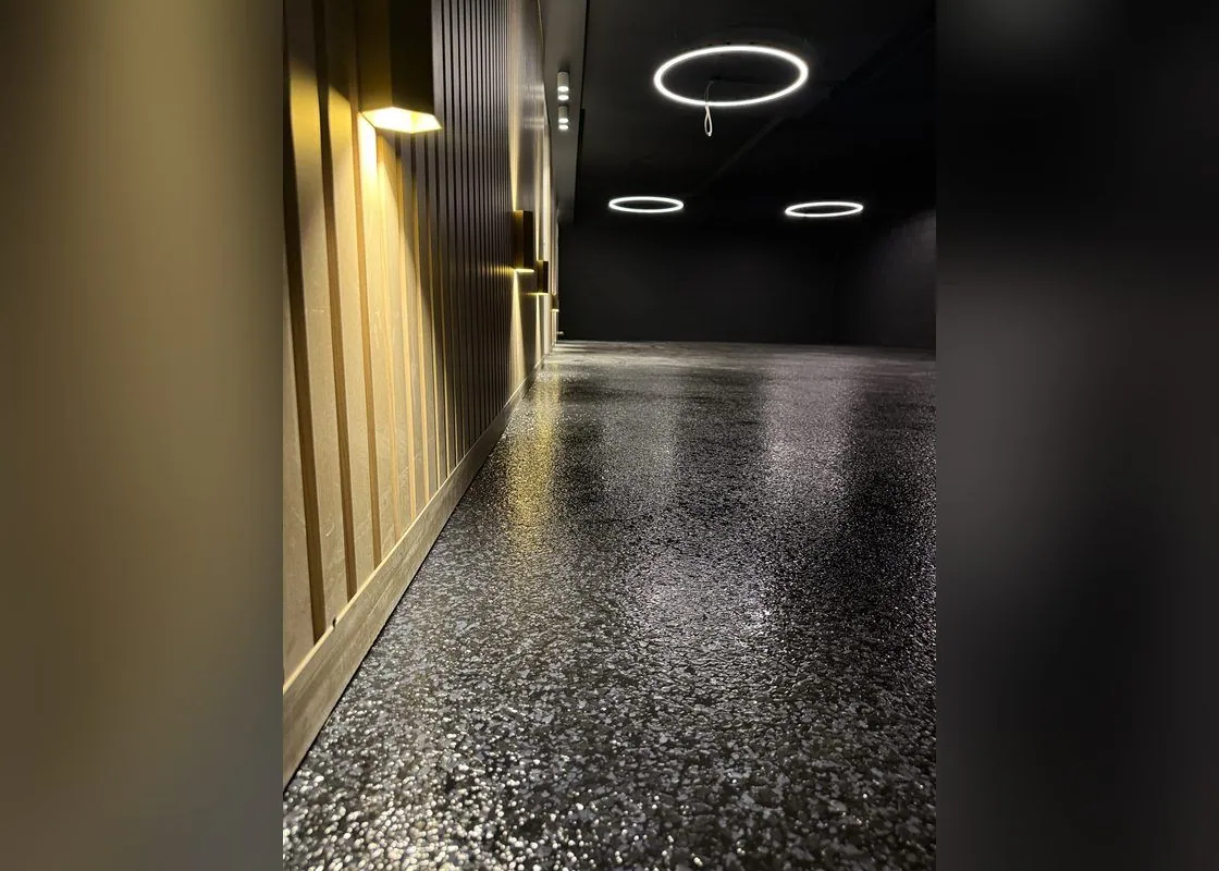 Black flake epoxy garage floor Black flake epoxy garage floor with a feature timber slat wall and ring lights in Brisbane