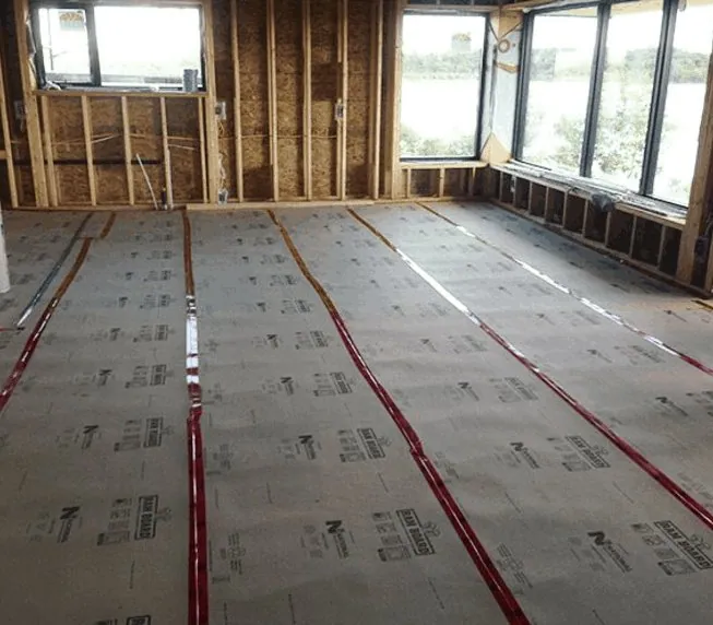 Breathable protection board taped down over a polished floor during construction, Brisbane
