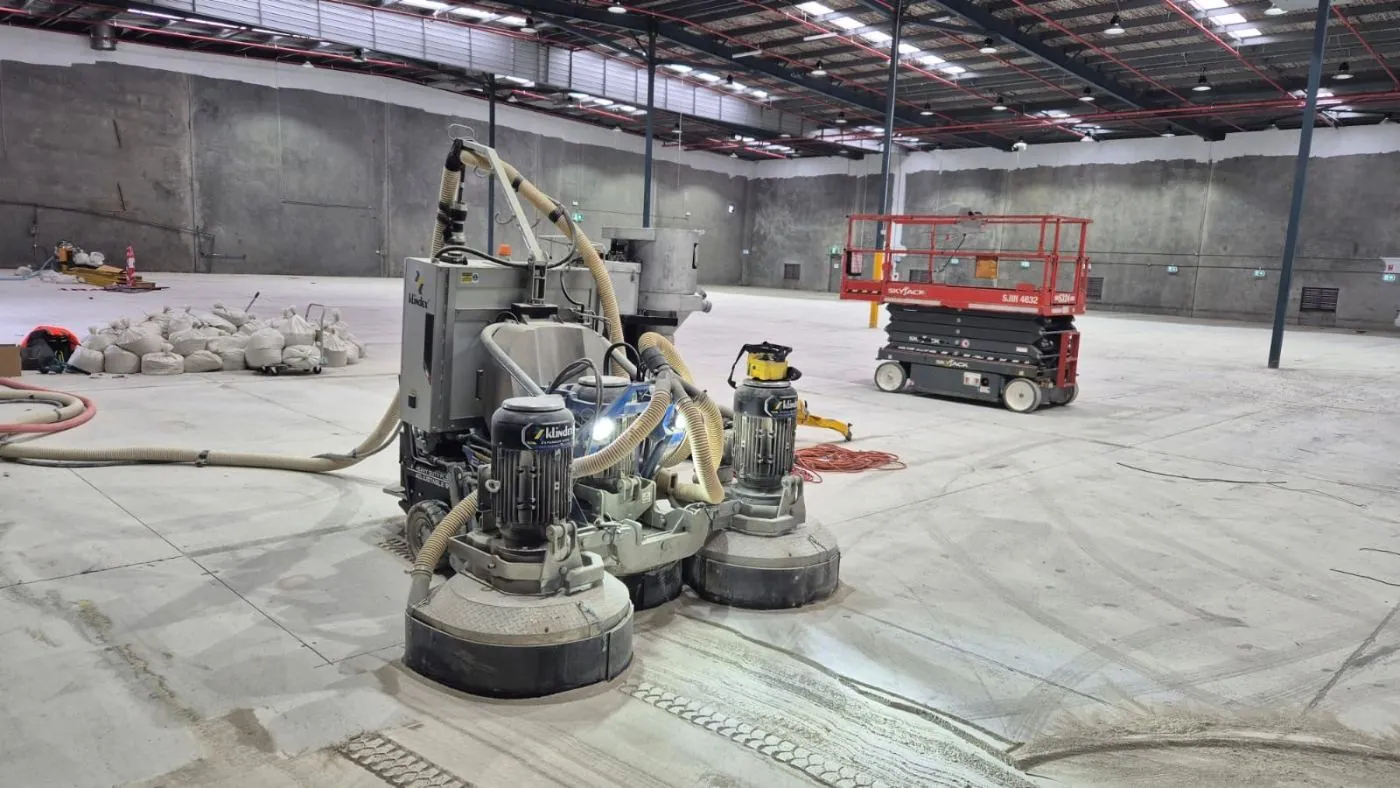 Planetary concrete grinder preparing a Brisbane warehouse floor