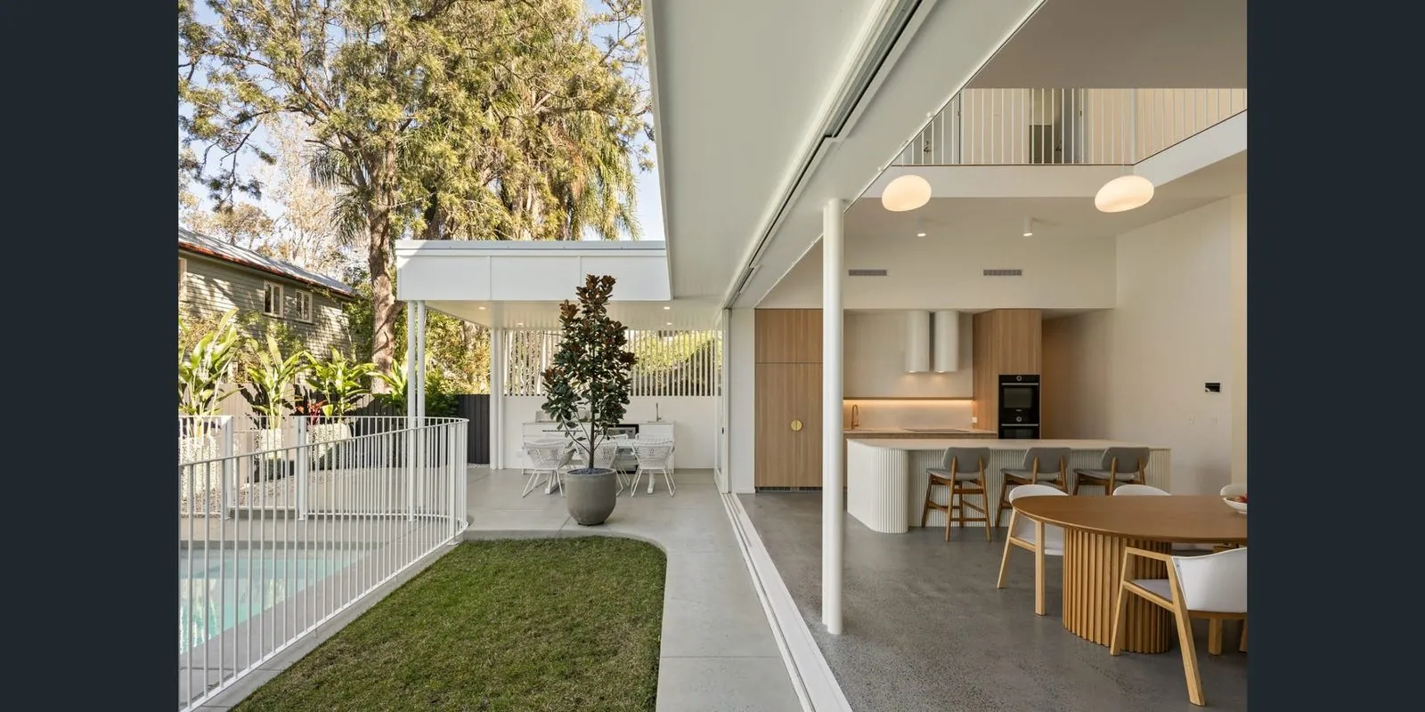 Sealed concrete floor in a Brisbane home opening to a poolside alfresco