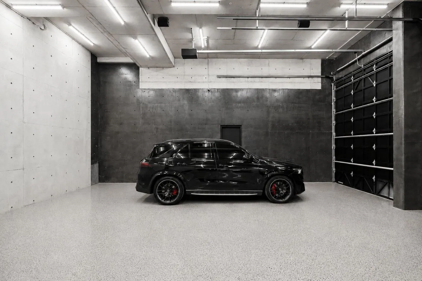 Flake epoxy garage floor with a black SUV in a Brisbane concrete garage