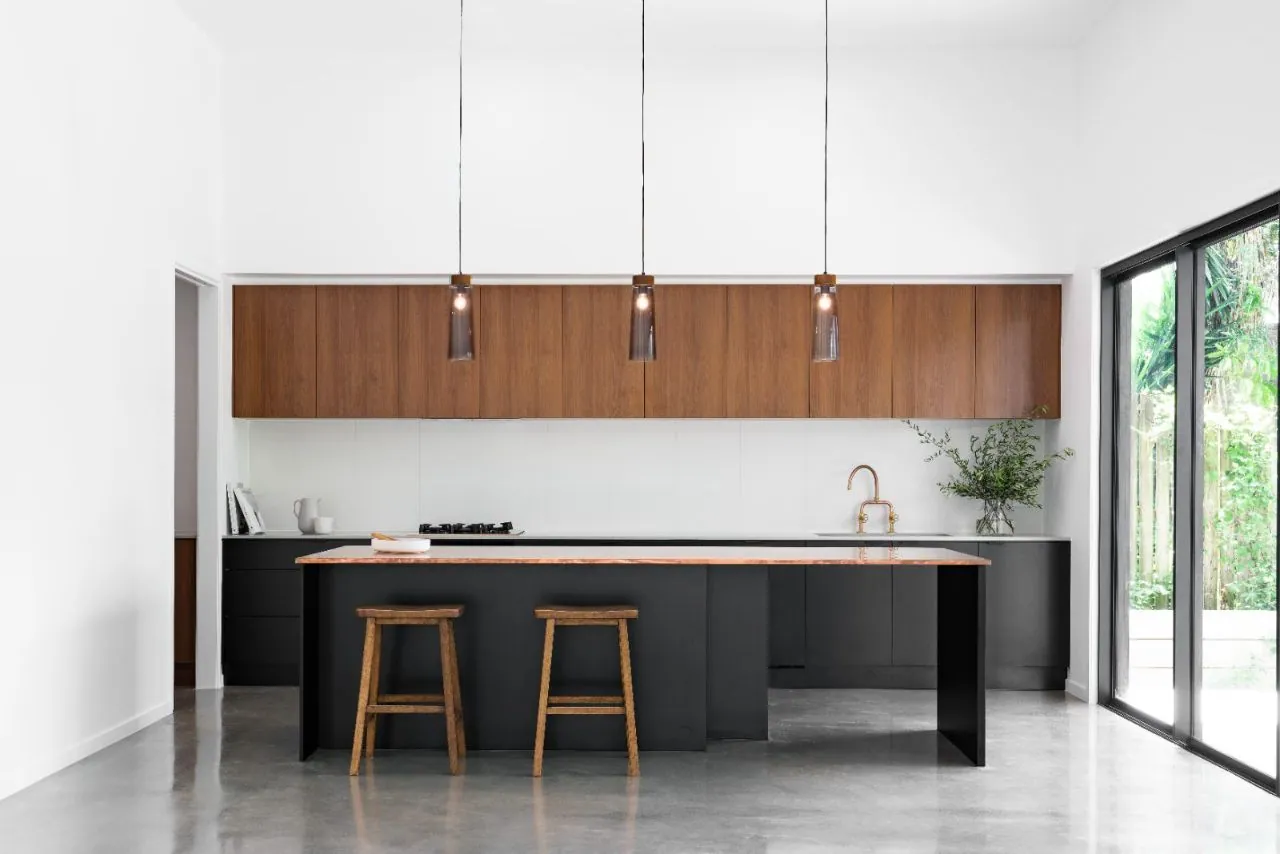 MPC matte polished concrete in a kitchen with black island and copper top