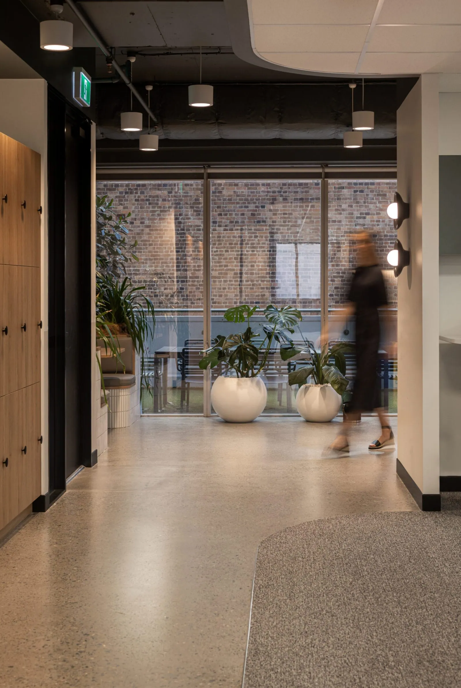 Grind and seal polished concrete floor in a corridor leading to an office breakout at the Archway commercial office fit-out, Brisbane