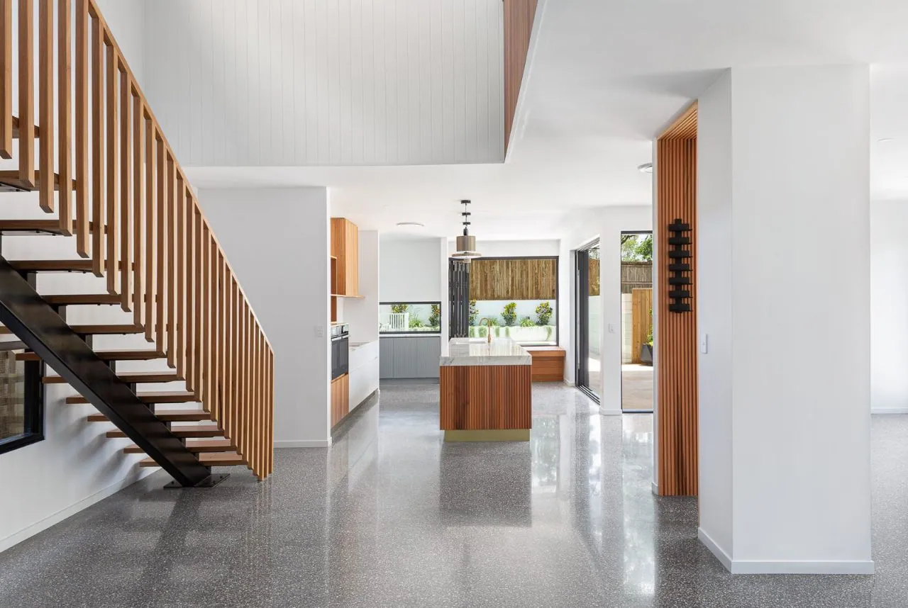 MPC high-gloss polished concrete in a white living area with timber stair