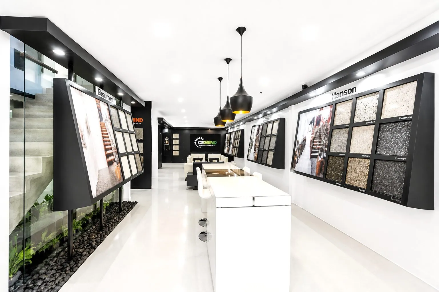 Inside the OzGrind polished concrete showroom in Eagle Farm with sample displays and the OzGrind logo screen