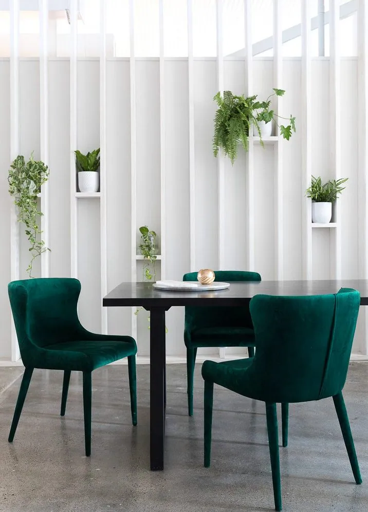 Green velvet armchairs on a polished concrete floor in the GlobeWest Brisbane showroom