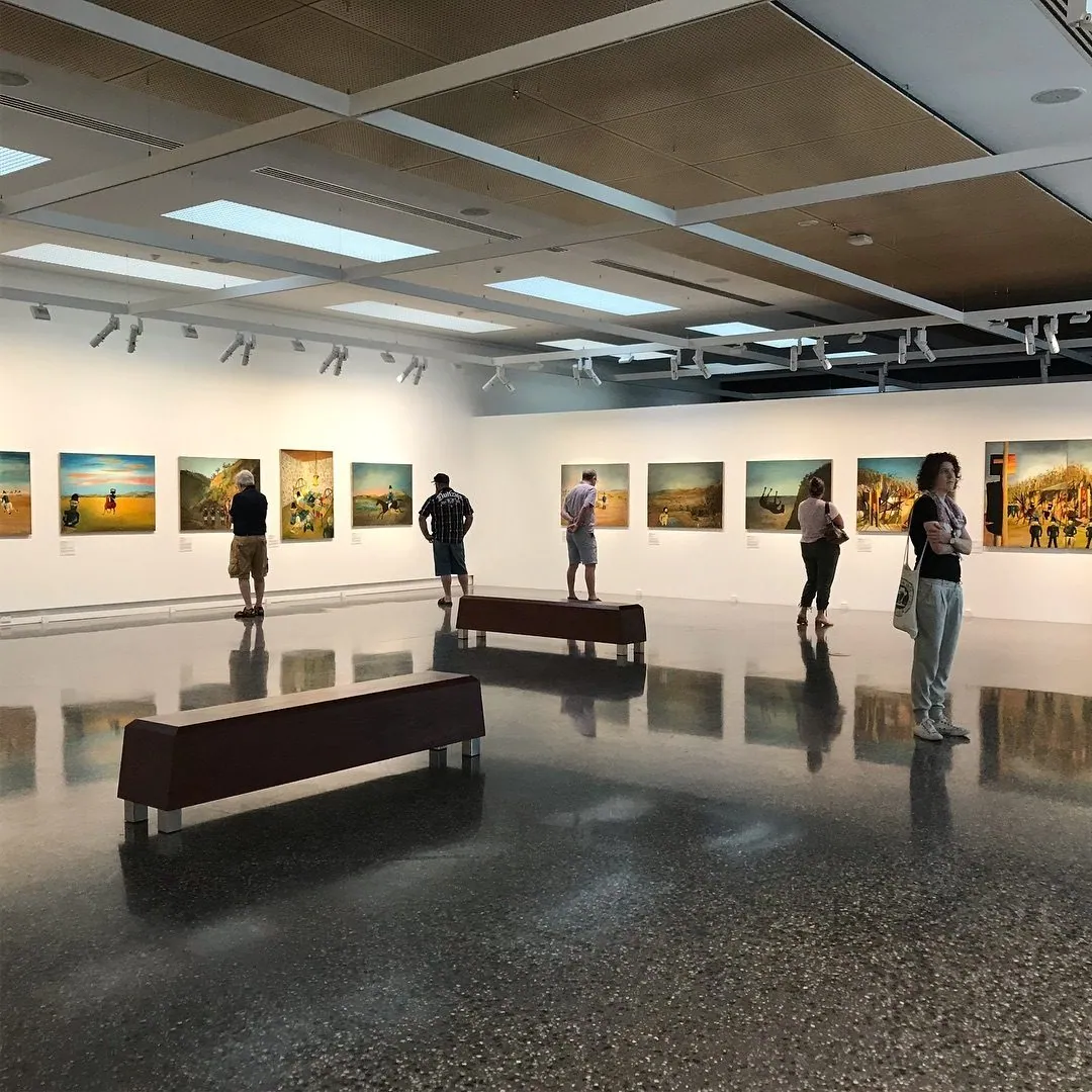 Exhibition hall with framed works and a polished concrete floor at Murray Art Museum Albury