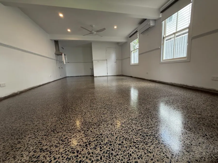 Warm brown full-exposure hybrid polished concrete floor in a Brisbane retail fitout by OzGrind